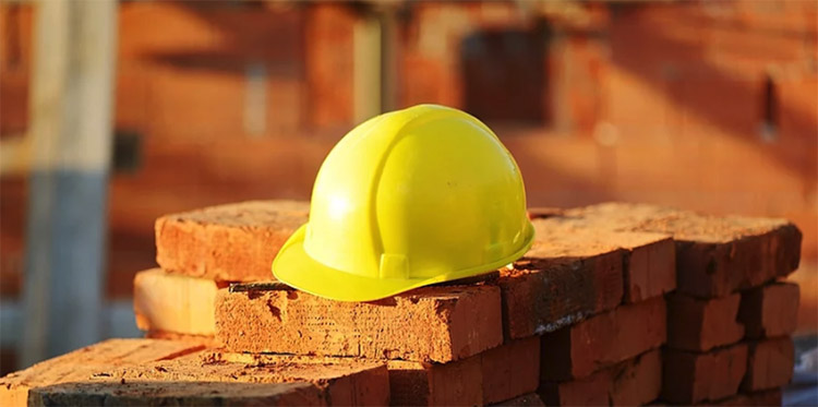 Construction hat on pile of bricks