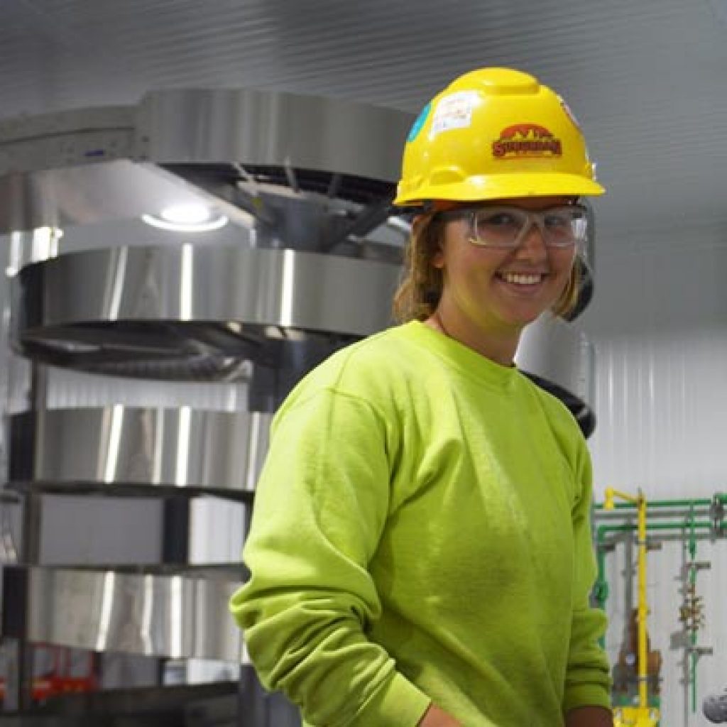 woman smiling with hard hat