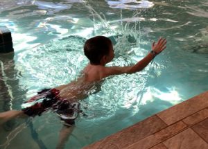 small child swimming