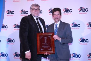 Bob Engler of Engler Services, left, presents the Wes Meilahn Award to Jack Vogel of Hill's Wiring
