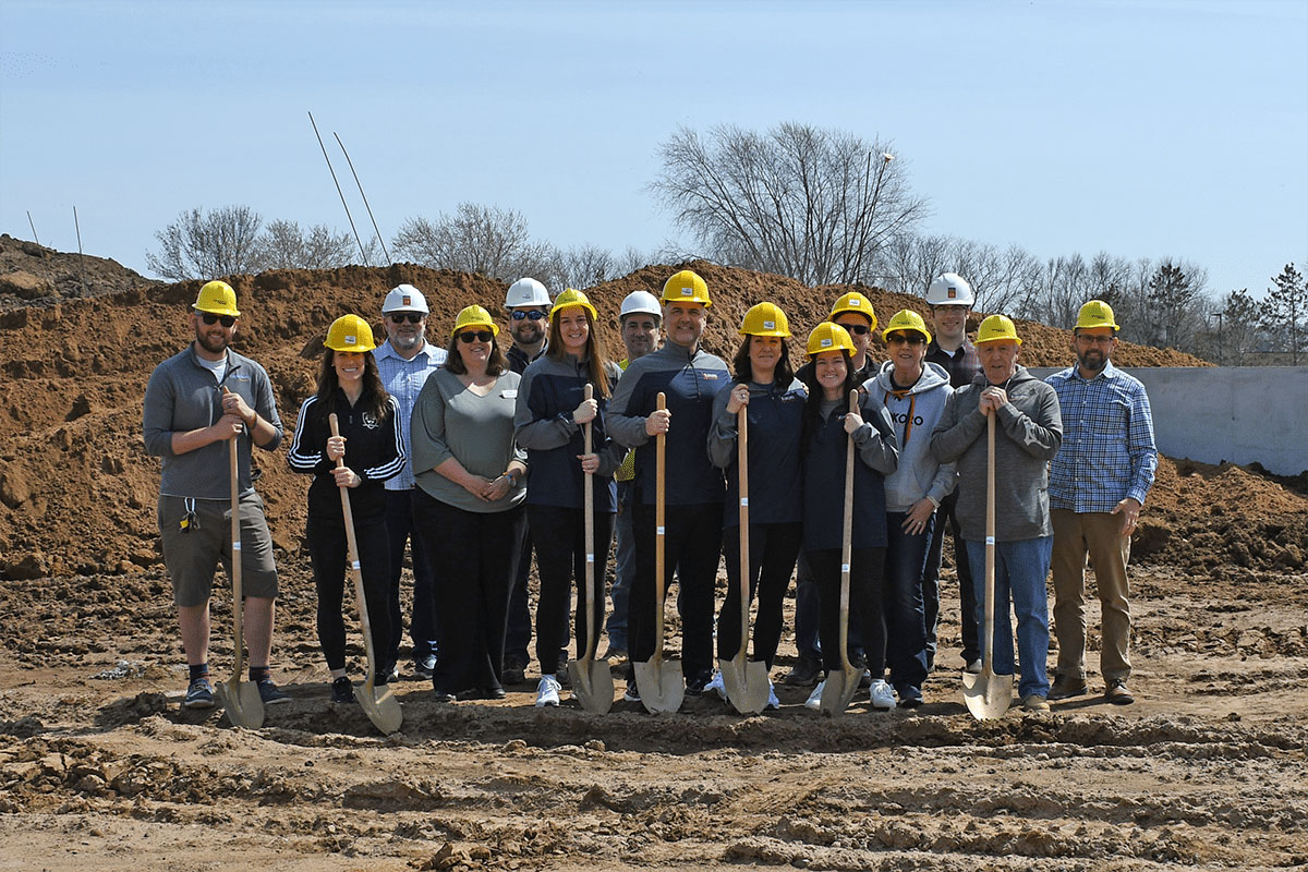 Kokoro Volleyball group with shovels and hardhats on future building site